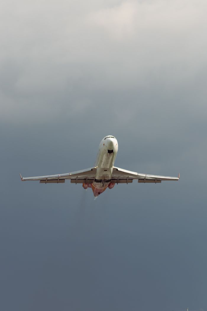 A commercial airplane takes off against a cloudy sky in Bogotá, Colombia.