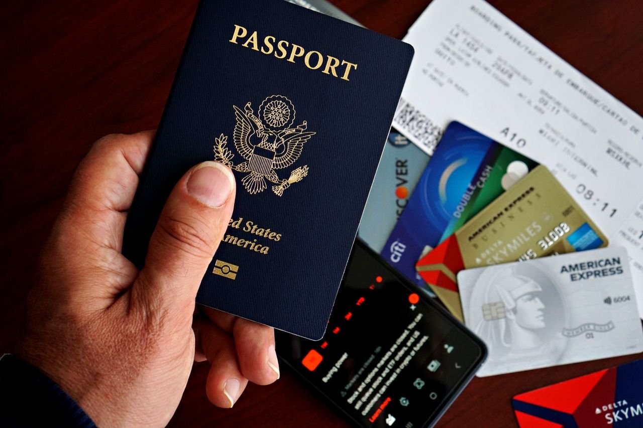 services-01 US passport with credit cards and travel documents on a table, travel preparation concept.