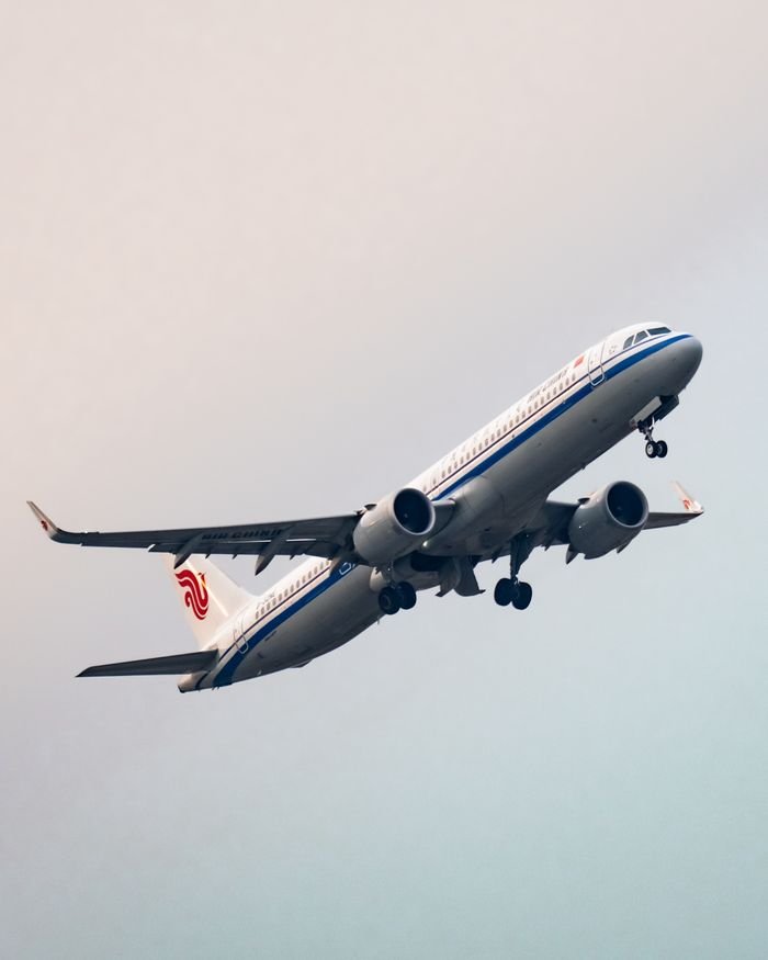 Crafting Captivating Headlines: Your awesome post title goes here A commercial passenger airplane captured in mid-flight, soaring high above Sepang, Malaysia's skies.