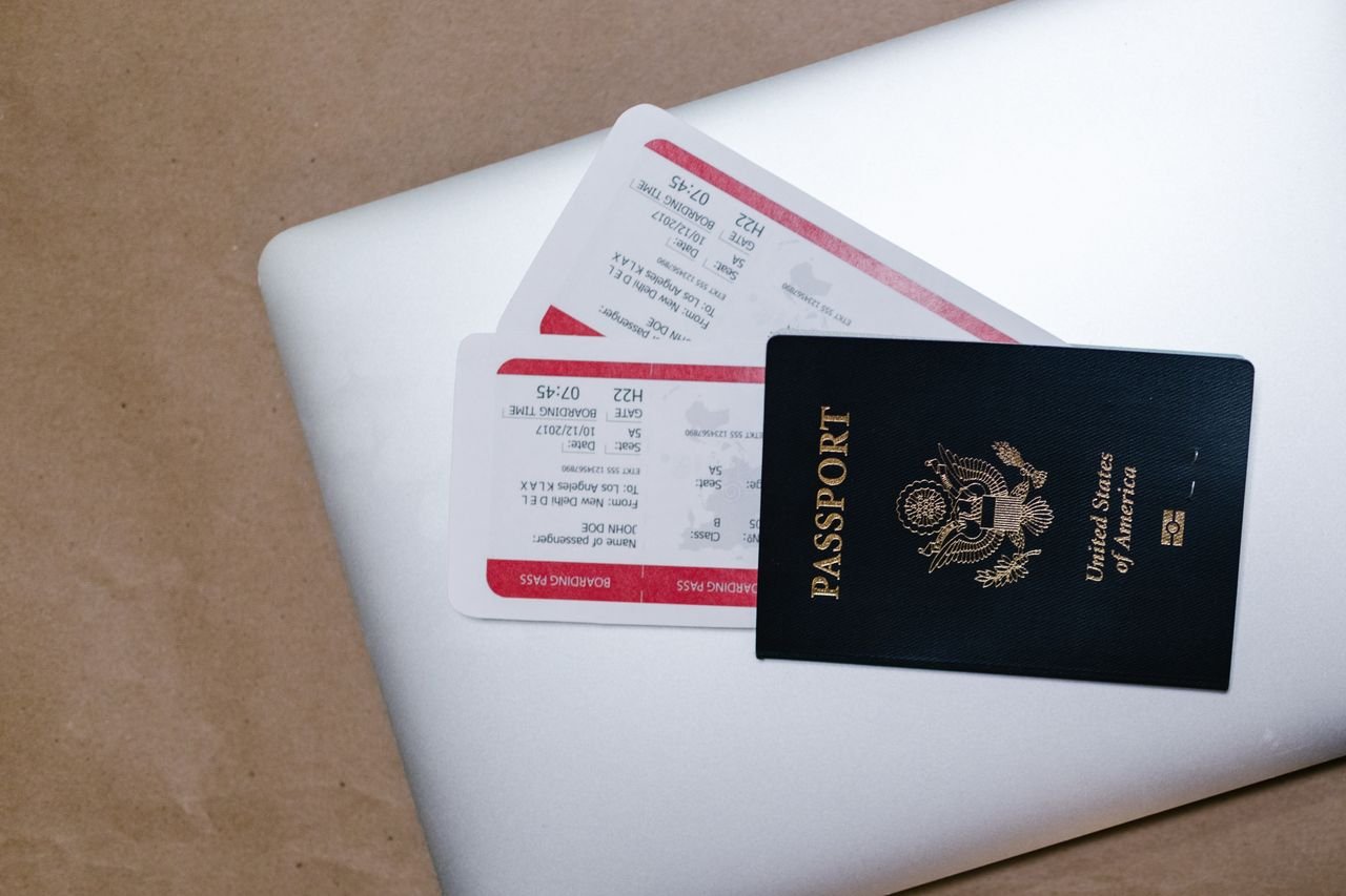heros-img Close-up of a passport and boarding passes on a laptop, symbolizing travel preparation.